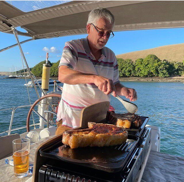 Steak cooking on a barbecue on the water