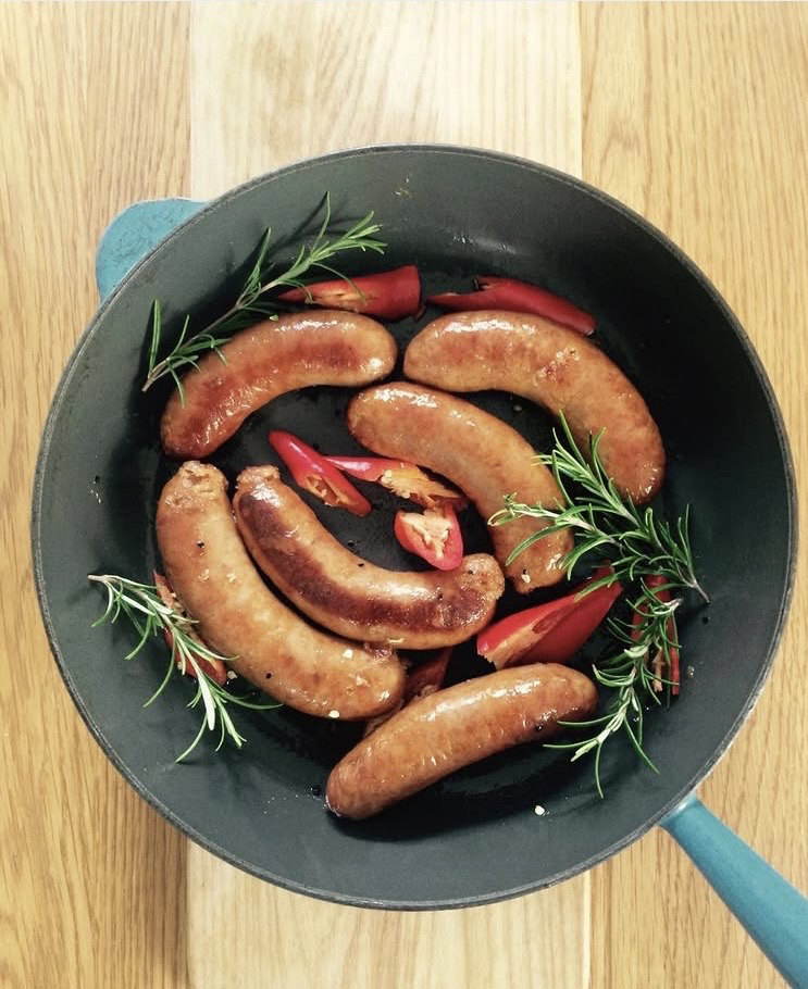 Sausages cooking in a pan